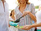 friends using tupperware black tongs to serve food