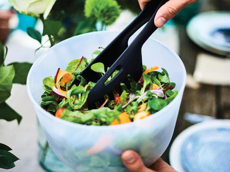 tupperware black tongs grabbing salad