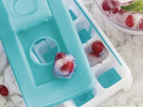 Tupperware Ice Tray with frozen grape cube on top of a marble table top