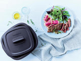 plate of steak and salad next to the tupperware micropro grill on a table