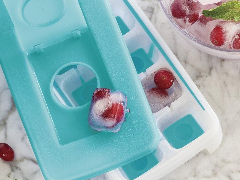 Tupperware Ice Tray with frozen grape cube on top of a marble table top