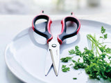 tupperware universal series kitchen shears with parsley on a white plate